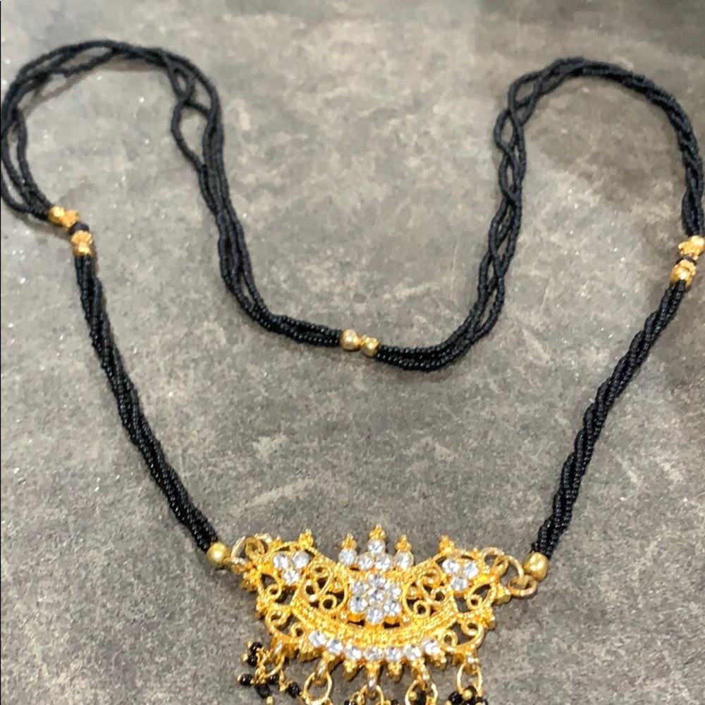 Black bead and gold tone crystal necklace.